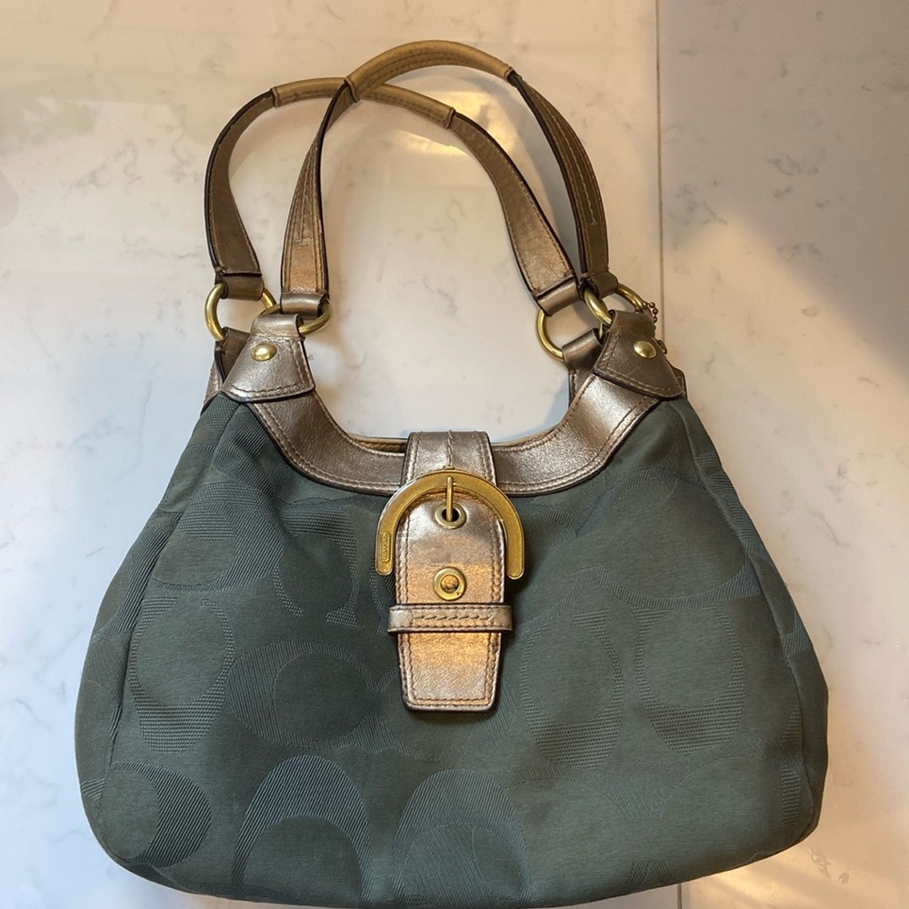 Coach handbag olive green with gold accents and buckle.